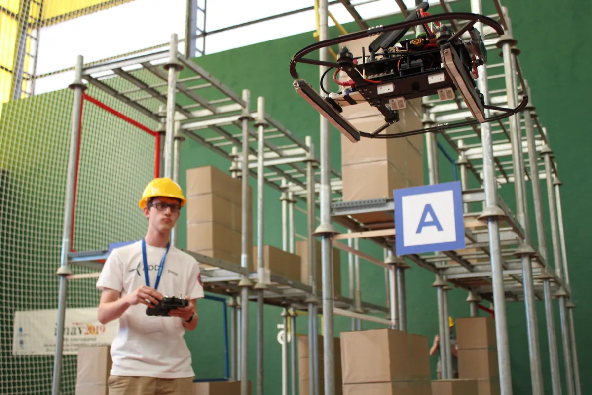 Drone flying through an indoor warehouse course